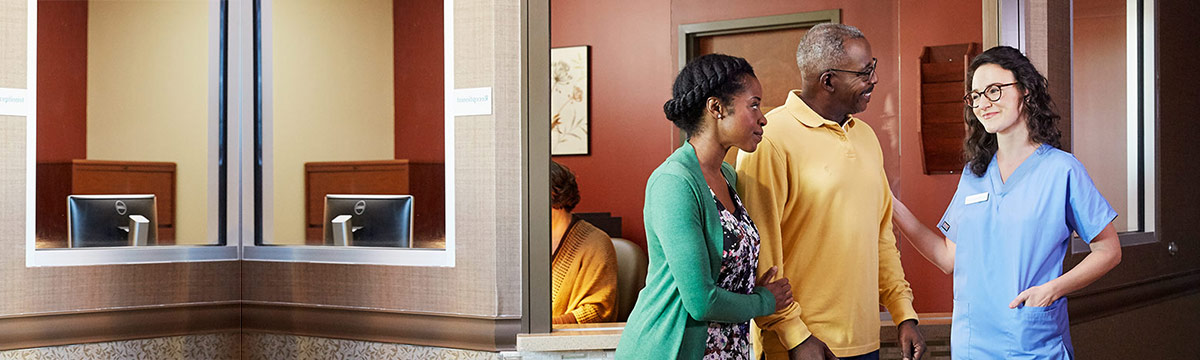 a dialysis caregiver with a patient and partner
